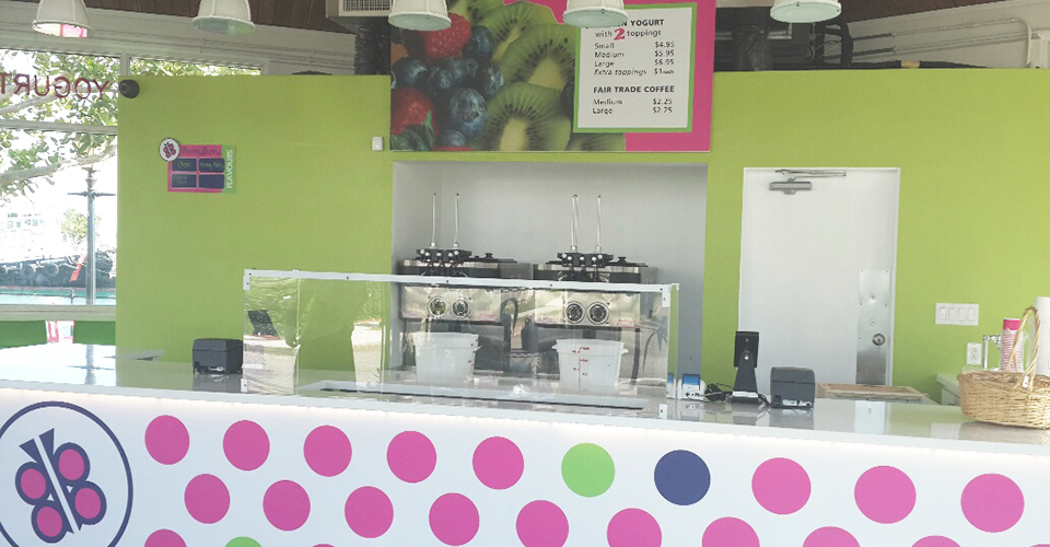 Polka dotted counter with a butterfly logo and bright green and pink colors